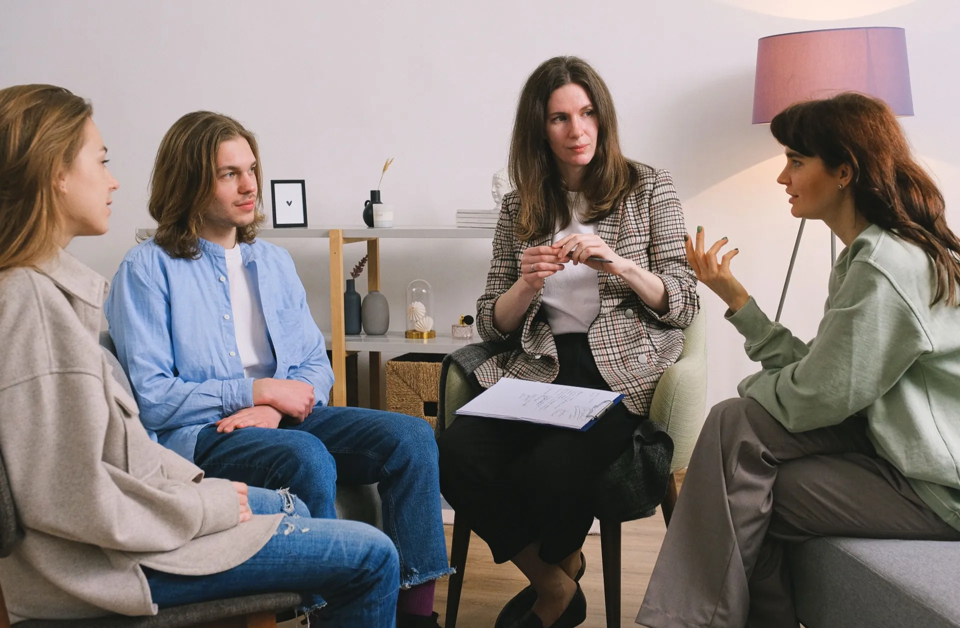 Three colleagues in conversation in a bright meeting room