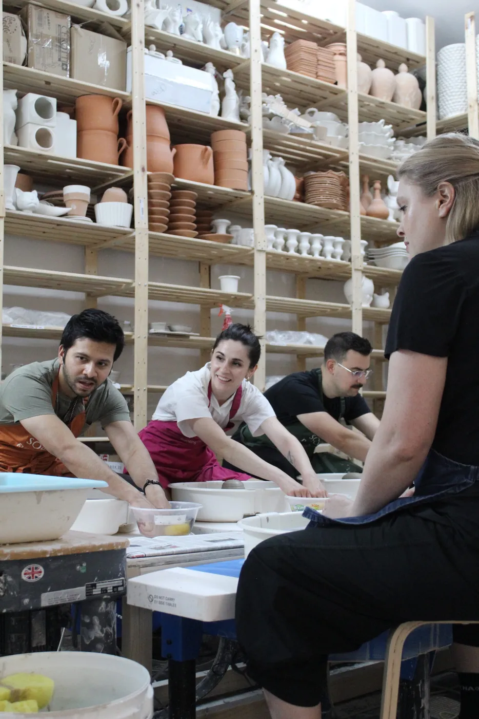 A smaller group painting pottery together