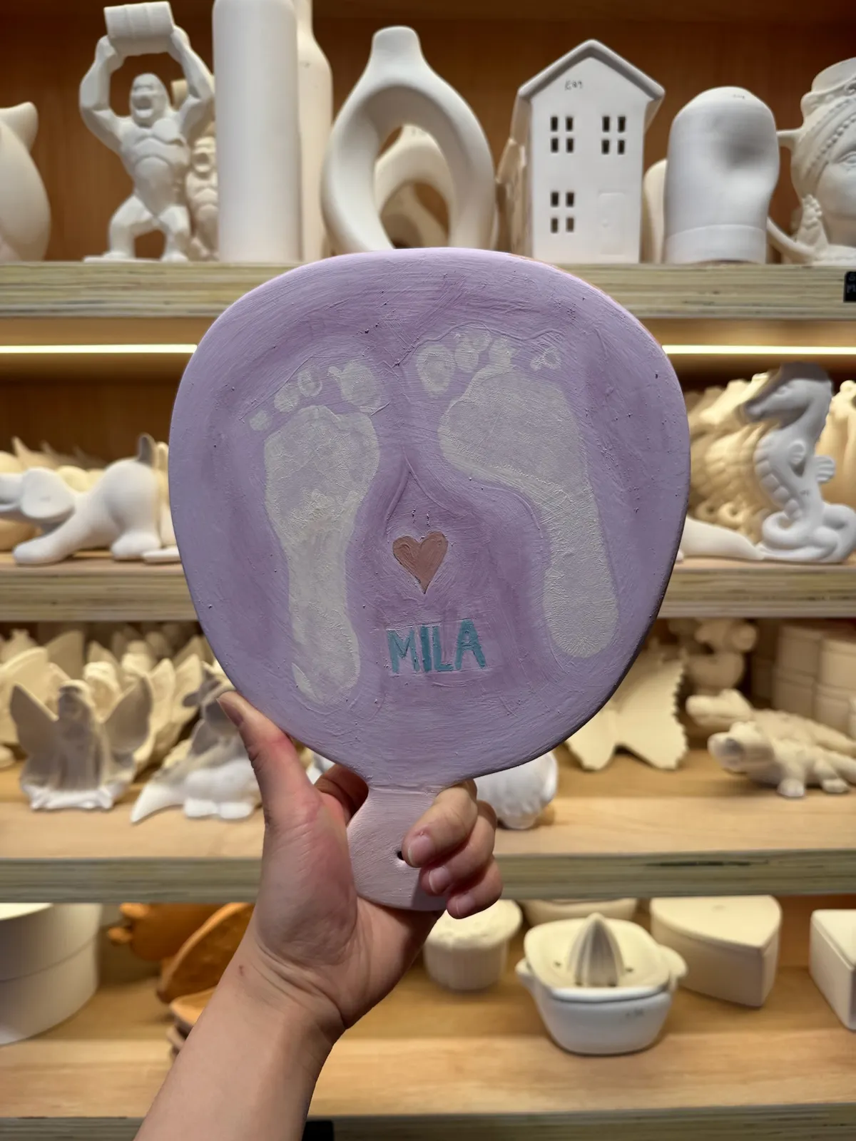 A hand-painted baby footprint keepsake plate