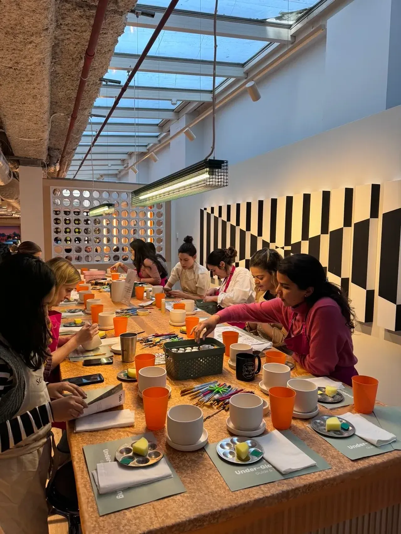 Guests painting pottery at their own venue