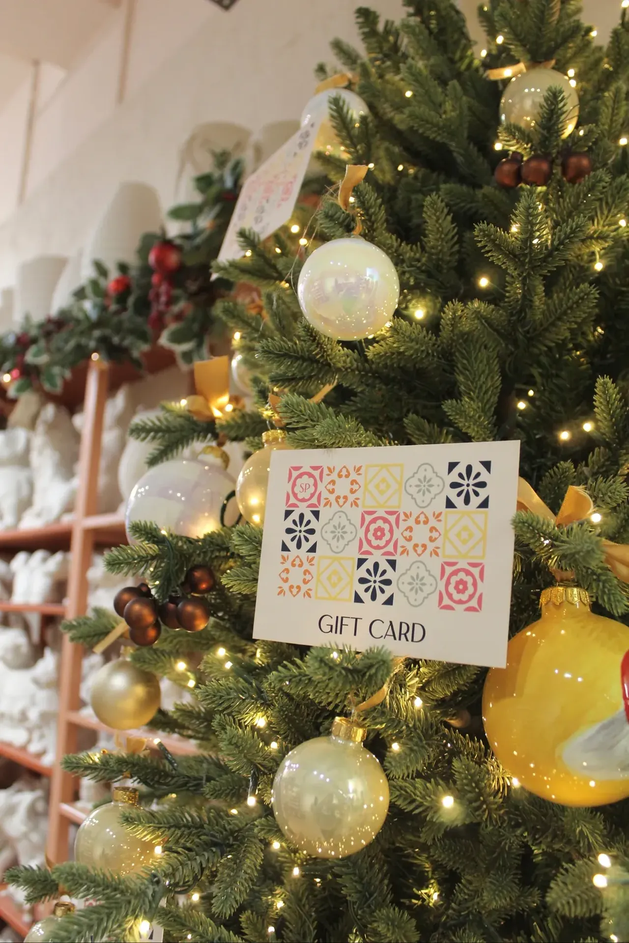 A Social Pottery gift card hanging in the Christmas tree