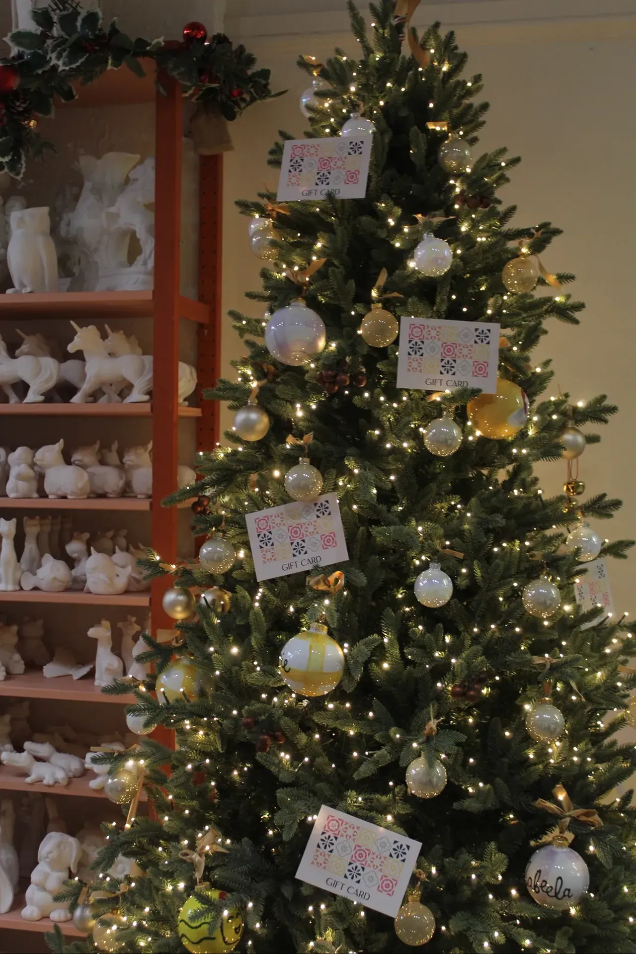 The gift-card tree beside the shelves of pieces