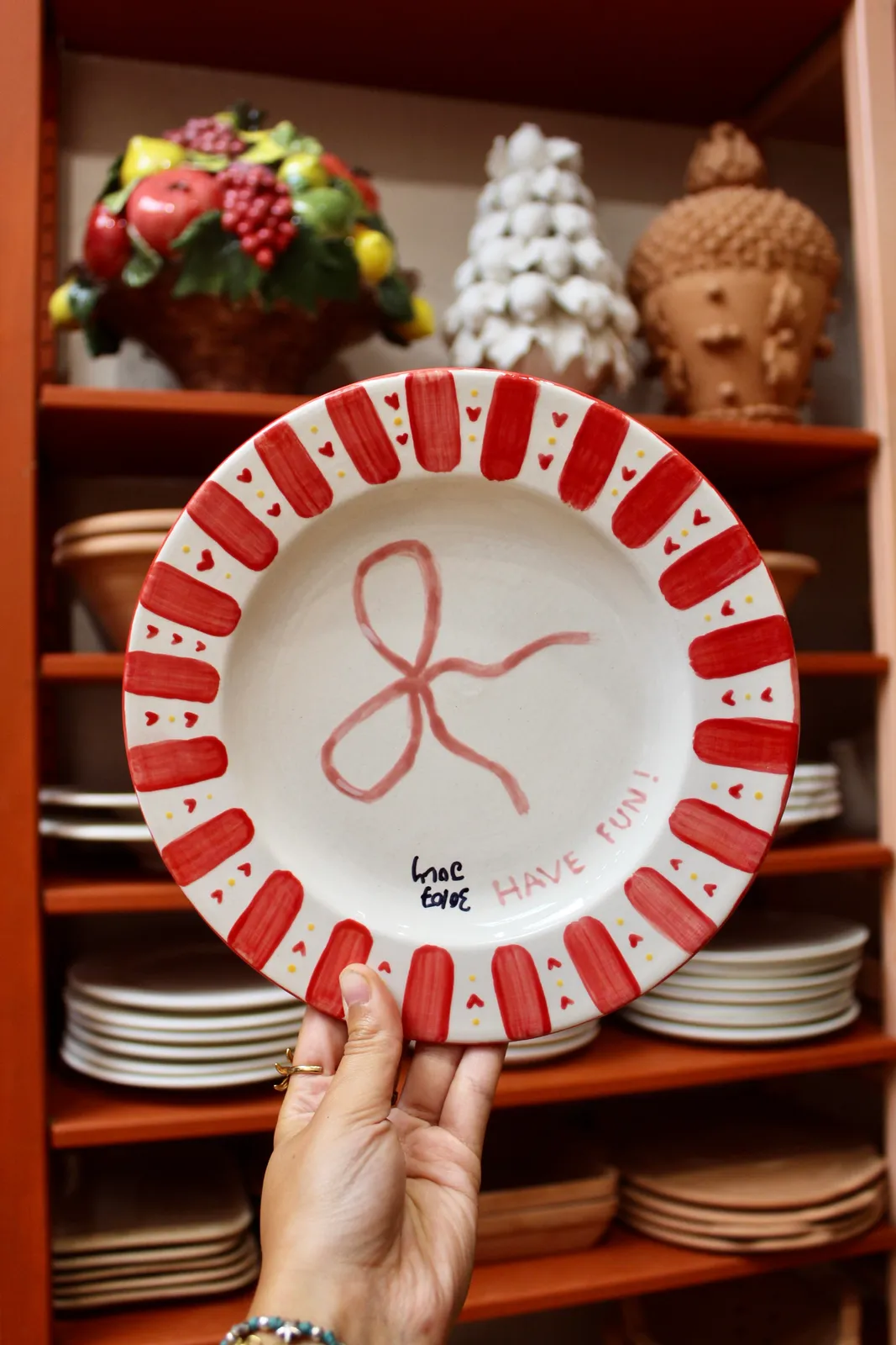 A finished hand-painted plate, fresh from the kiln