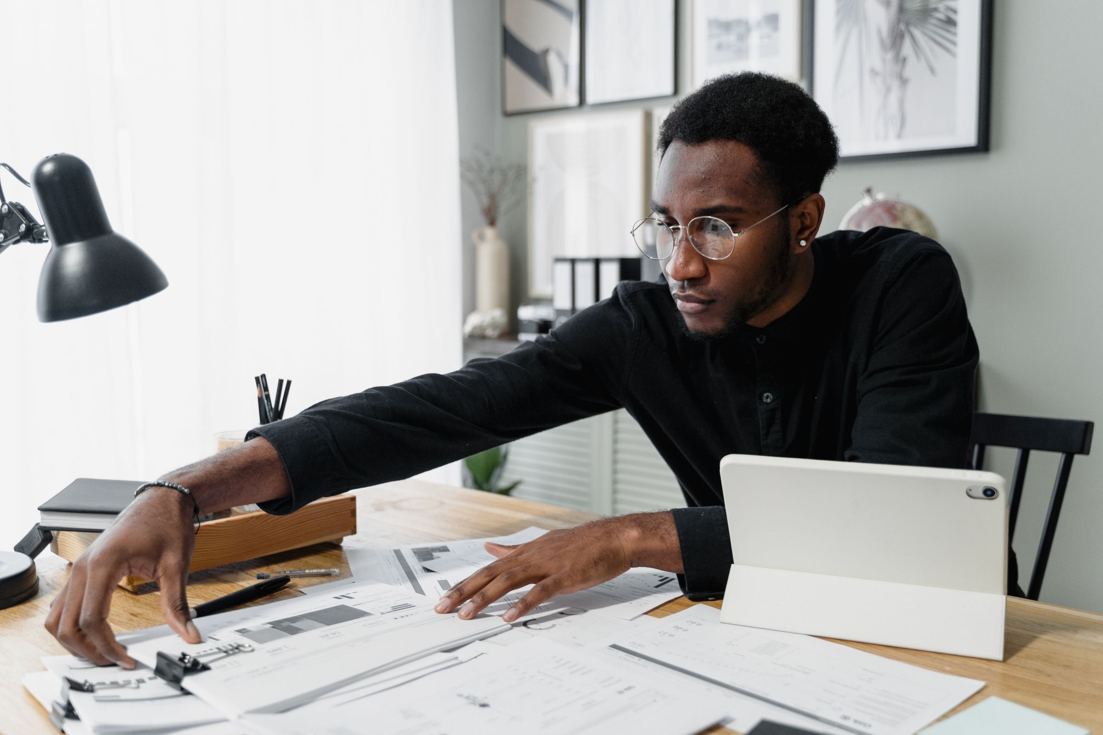 Fleet owner reviewing a shipper RFP and carrier scorecard on a tablet at an office desk