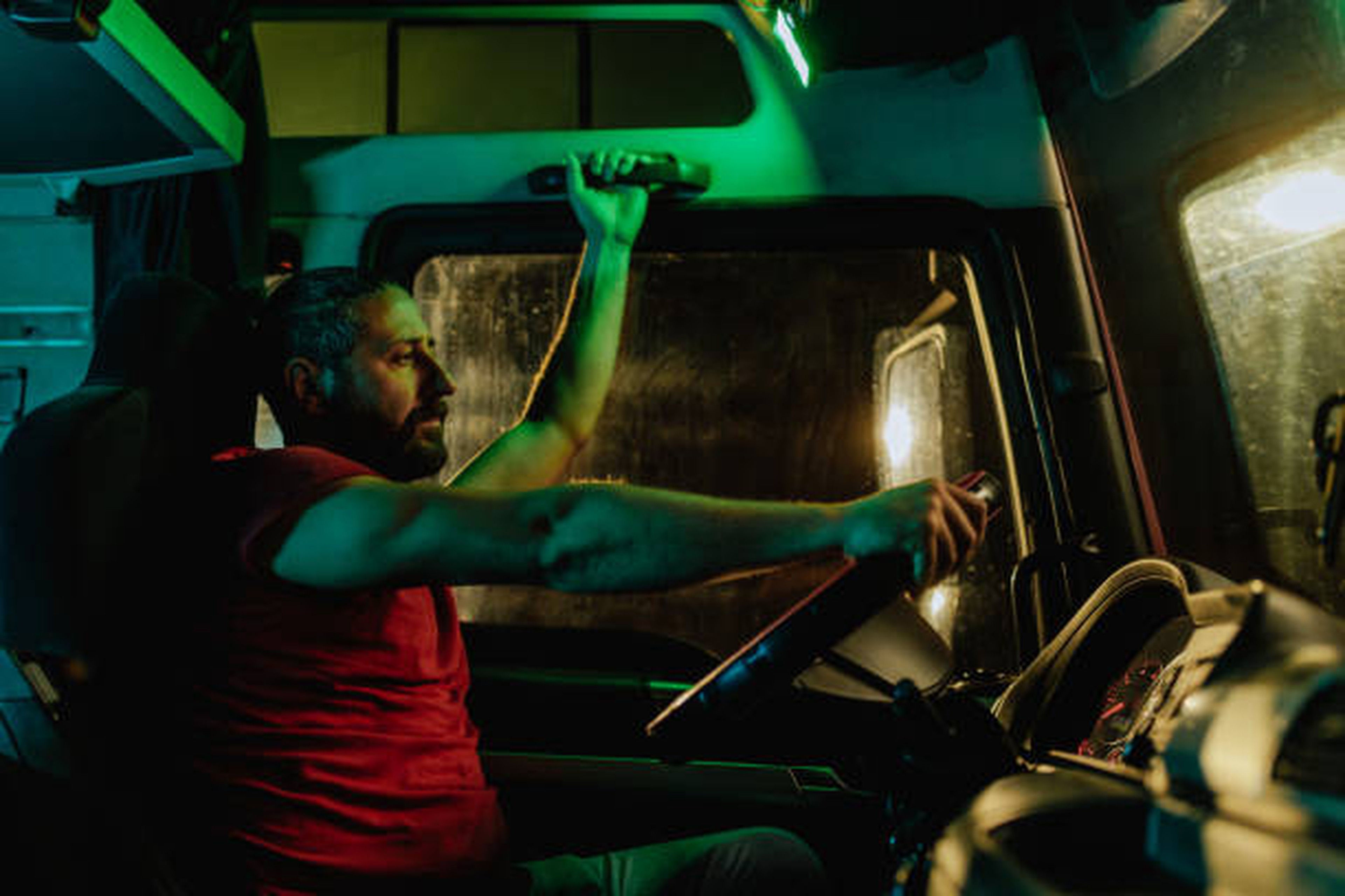 Trucker waiting inside the truck, in front of logistic platform