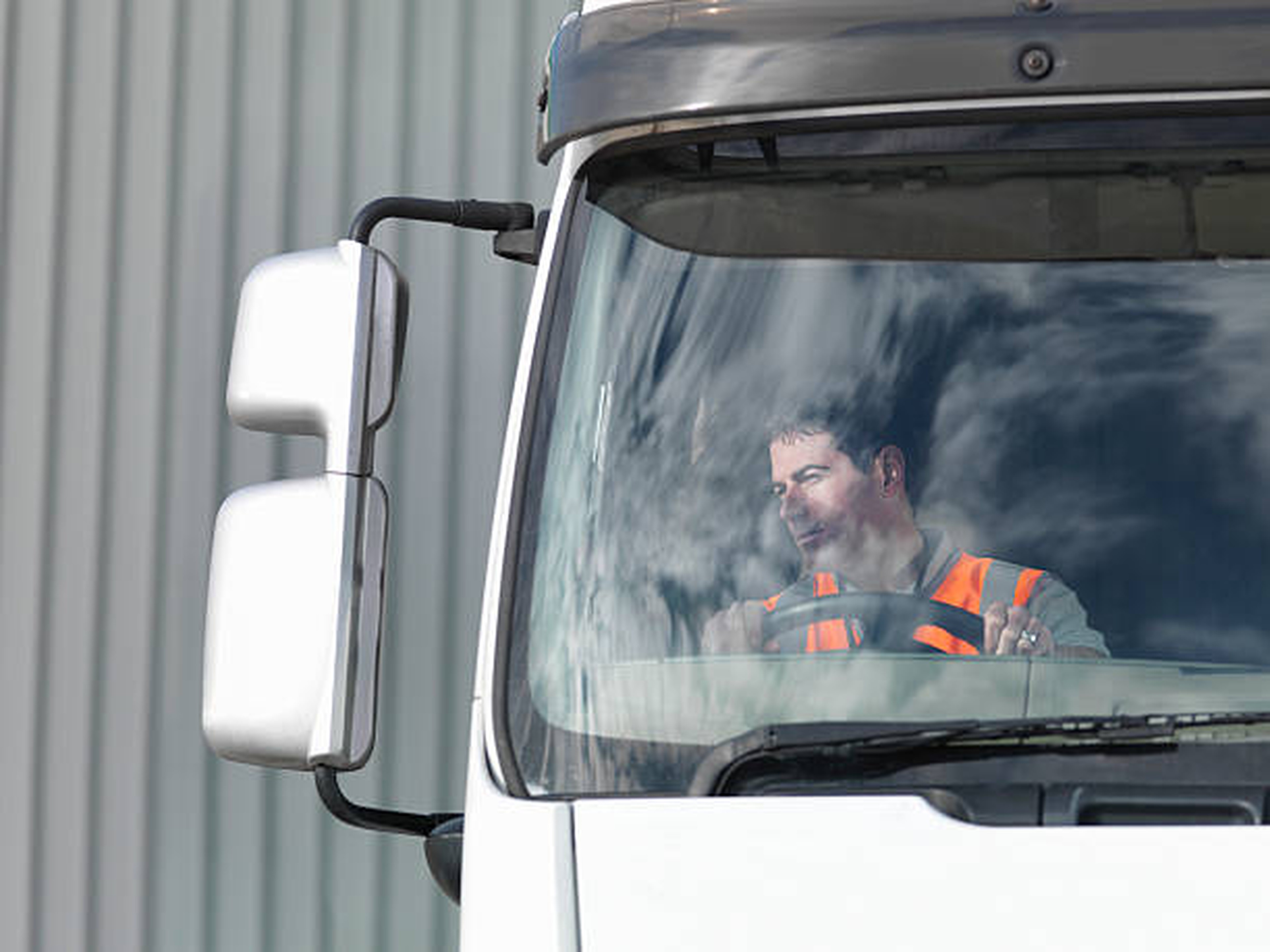 Driver waiting inside his truck to be loaded