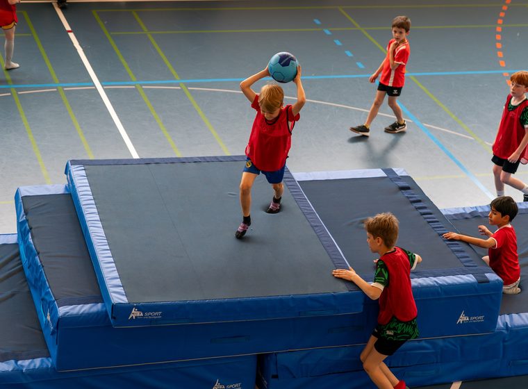 Kinder beim Basketballspiel mit Trampolin
