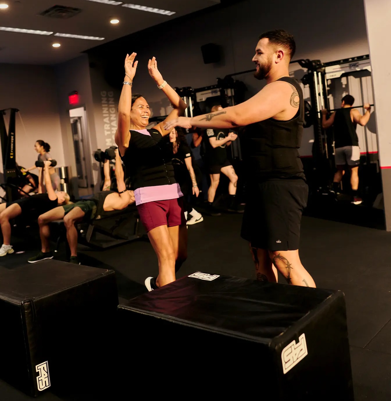 Two people doing a high five in an F45 Studio