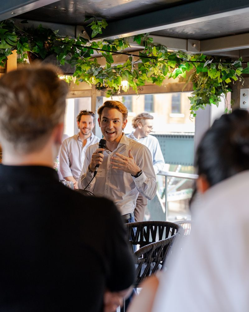 Sam Stark of Green Project addressing attendees at a networking event during London Climate Action Week