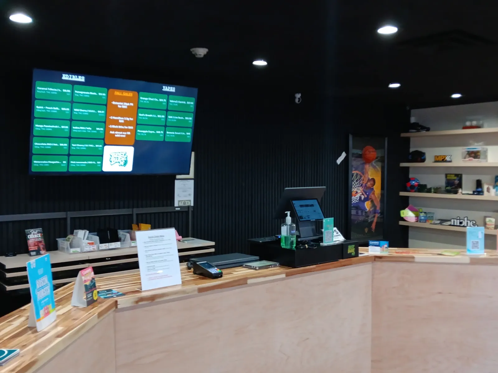 The Best Budz NJ counter with the register and the edibles and vapes menu screen