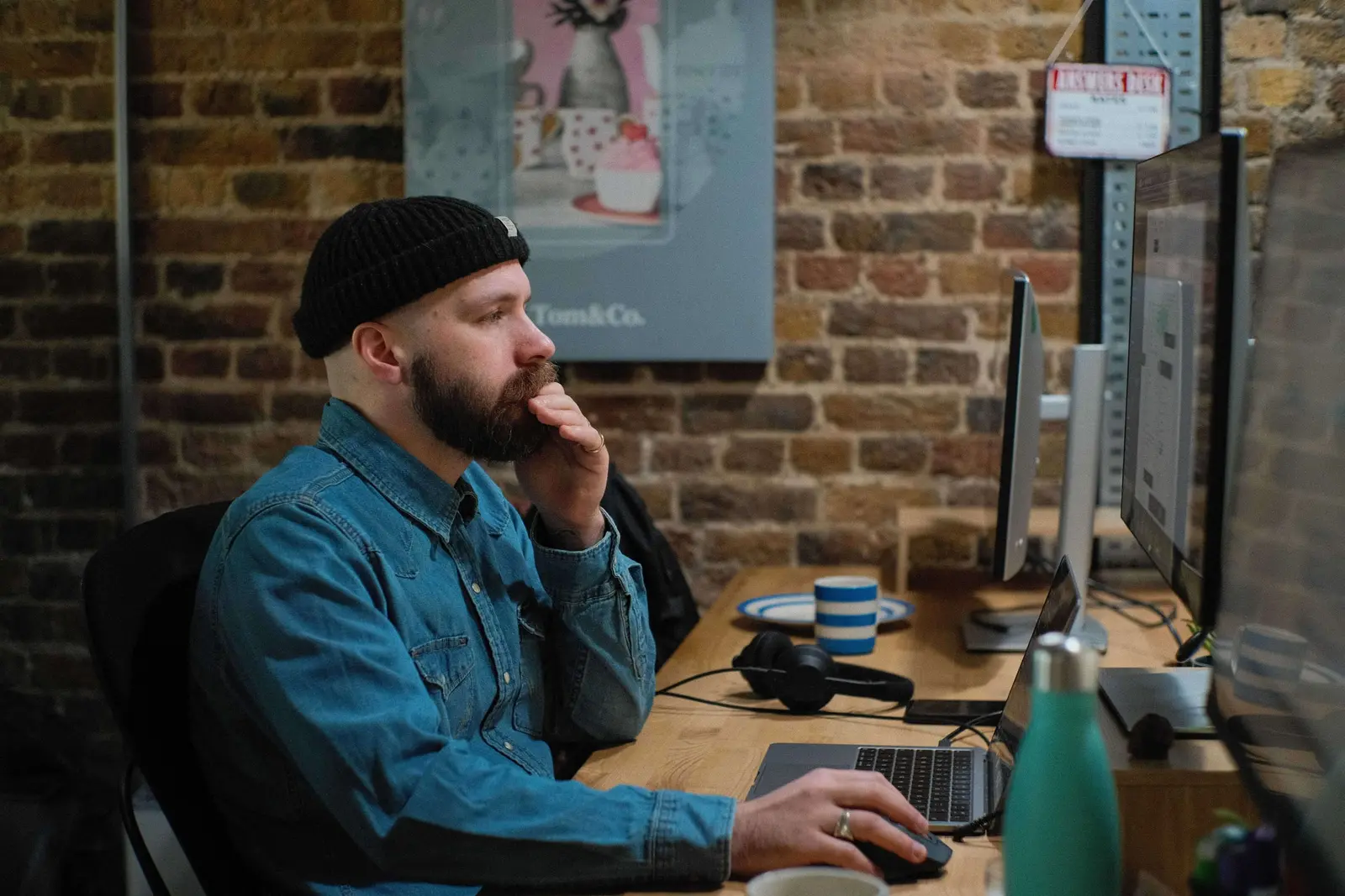 A Tom&Co team member working at their desk in the studio