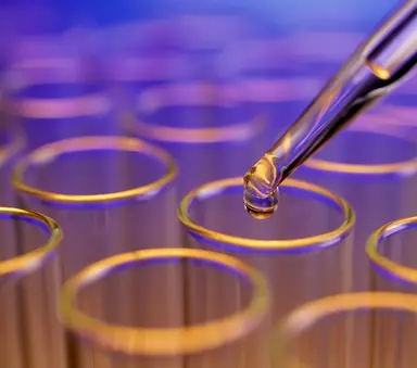 Laboratory pipette dispensing liquid into test tubes, representing oligonucleotide synthesis, molecular biology research, assay development and nucleic acid workflows.