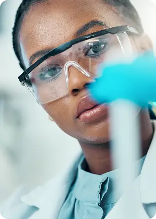 Laboratory researcher examining a sample in a modern scientific environment, representing global scientific operations, international collaboration, diagnostics, genomics and life sciences expertise.