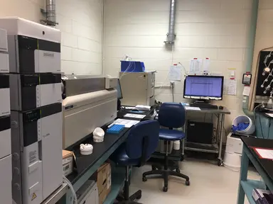 Analytical laboratory equipped with chromatography instrumentation, computer workstations and sample processing equipment used for assay testing, analytical performance evaluation and laboratory research workflows.
