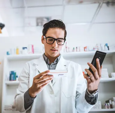 Laboratory professional reviewing molecular biology reagents, representing scientific support for PCR assay design, genotyping and molecular testing workflows.