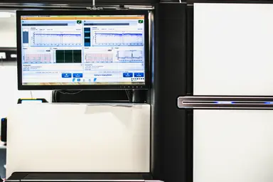 Automated genomic analysis system displaying assay data for oligonucleotide development and analytical workflows.