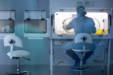 Controlled laboratory environment supporting therapeutic oligonucleotide synthesis materials production.