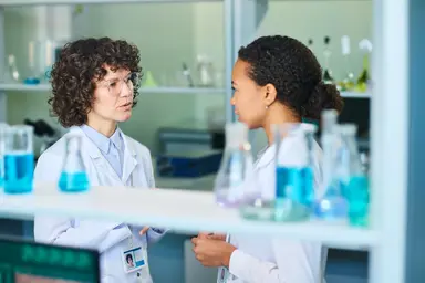 Scientists discussing next-generation sequencing workflows and custom oligonucleotide solutions in a laboratory environment.