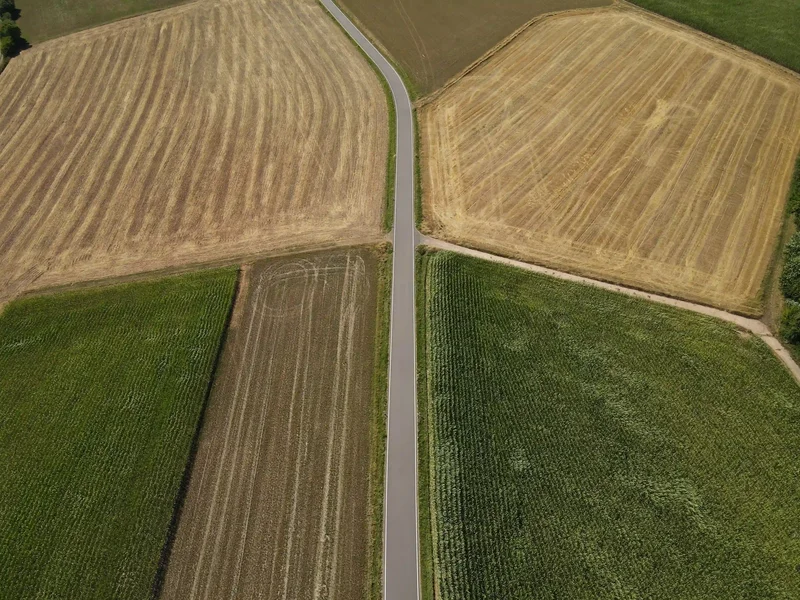 Agriculture drone for elevated insight | DeltaQuad Evo Enterprise farming drone flying over green and yellow land