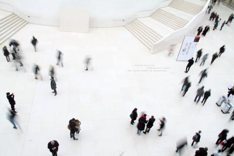 People move through a conference space.
