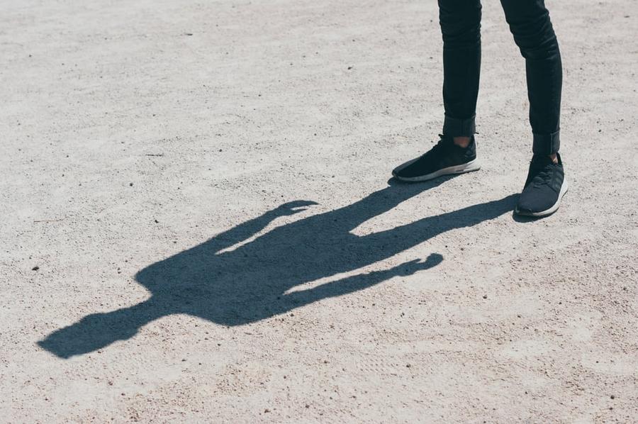 A shadow extends from a person's feet.
