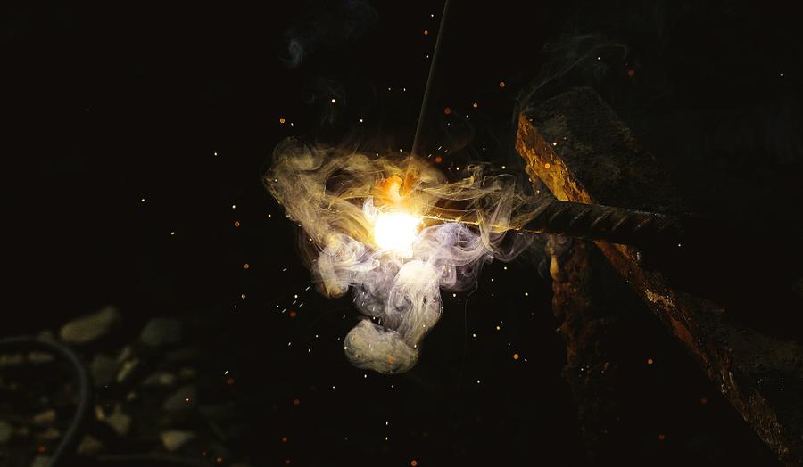 A piece of iron with bright white sparks on one end.