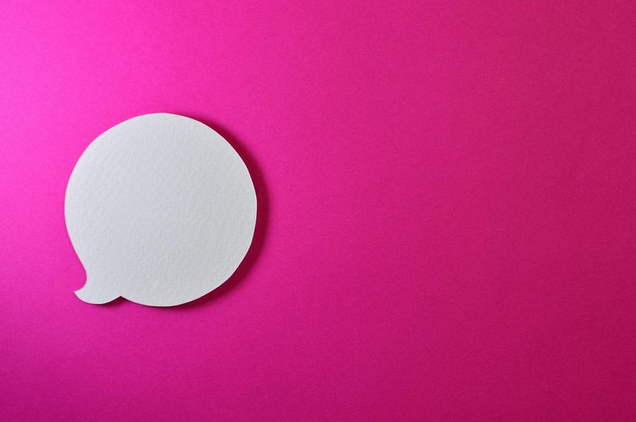 A white speech bubble with a pink background.