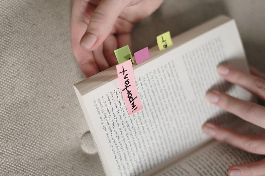 An open book with a pink sticky note on a page labeled "Important."