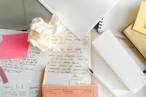 A mess of papers on a desktop.