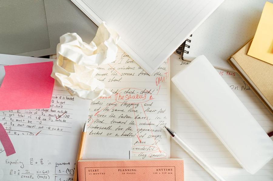 A mess of papers on a desktop.
