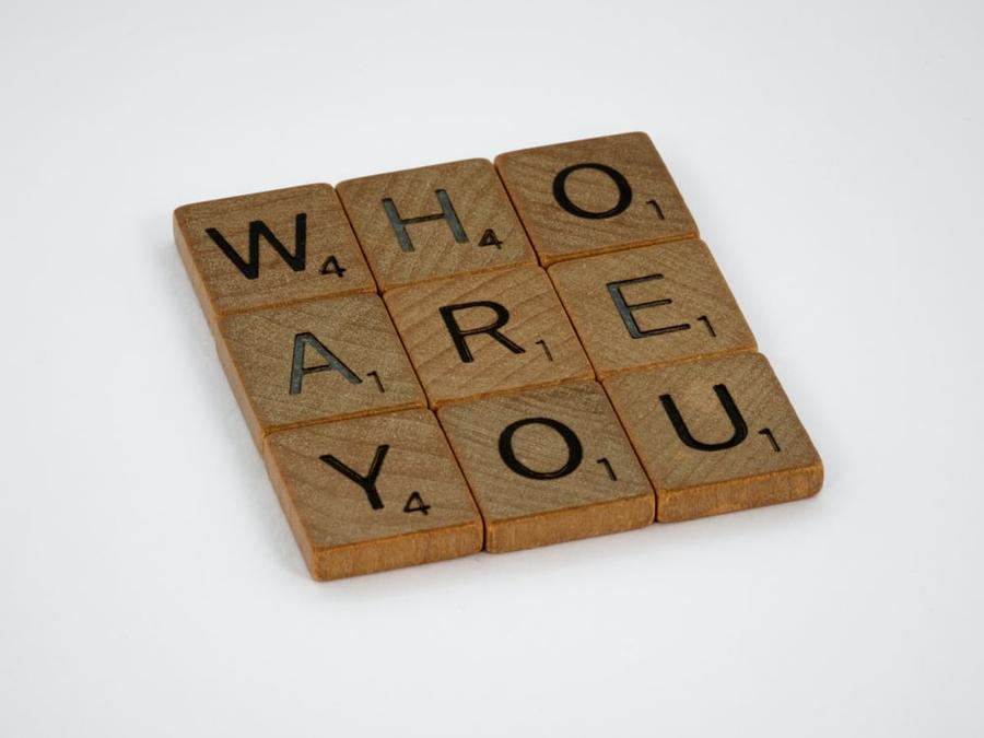 Wooden tiles spelling "who are you"