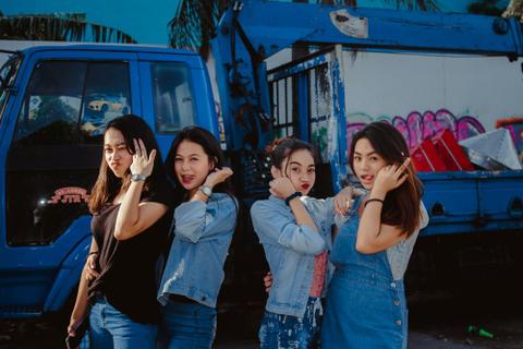 Four teenage girls pose together.