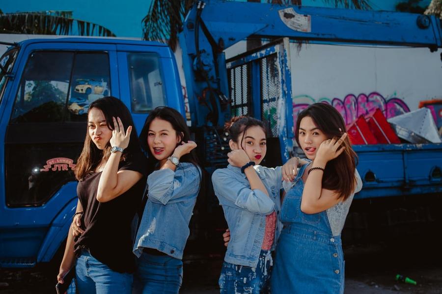 Four teenage girls pose together.
