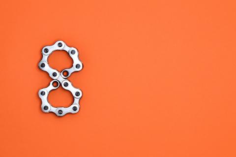A metal number eight against an orange background.