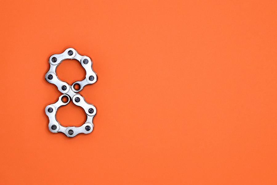A metal number eight against an orange background.