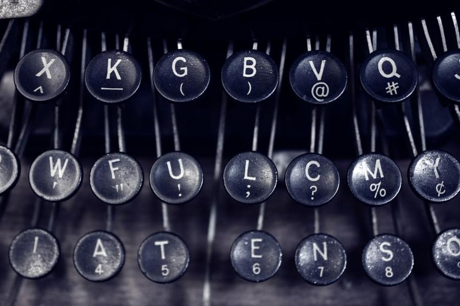 Close up of a typewriter keyboarder, focusing on keys with punctuation, including double and single quotes.