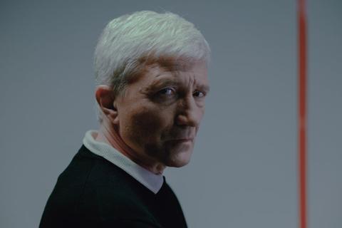 An older, serious-looking person.