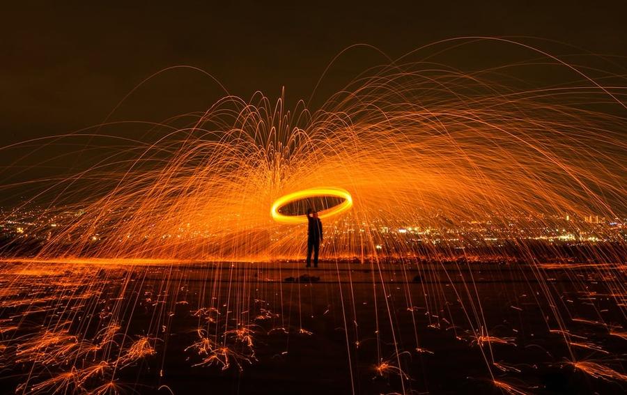 A man with a circle of sparks above him