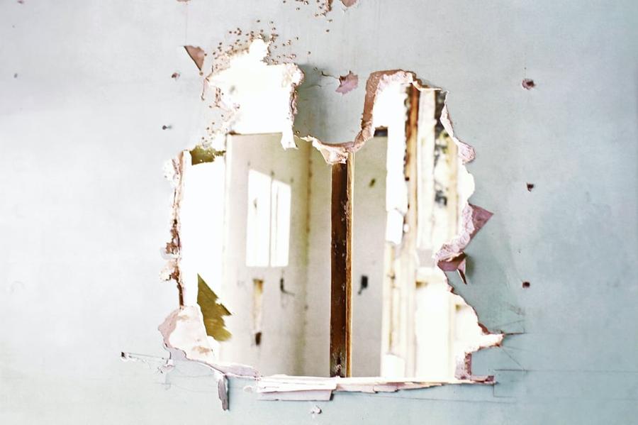 A broken wall made of drywall.