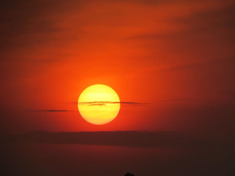Orange sunset with a yellow sun.