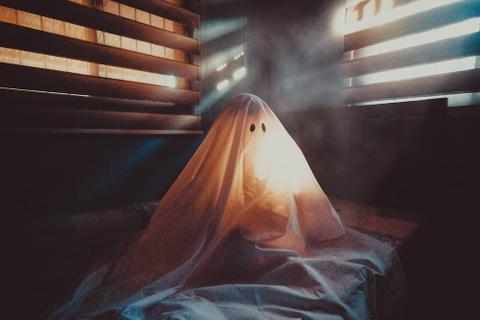 A sheet with eyes and a mouth cut out to make a ghost.