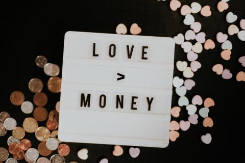A sign with the theme "Love is greater than money."