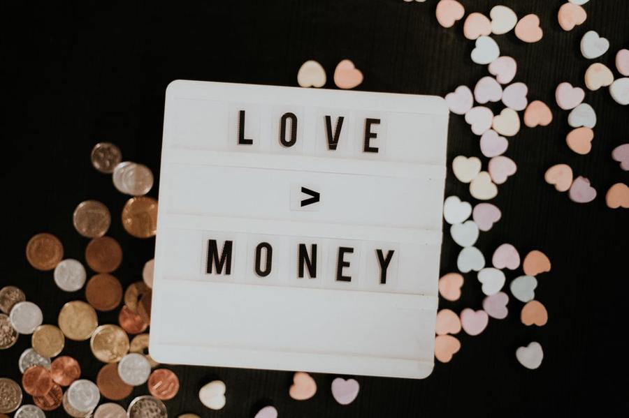 A sign with the theme "Love is greater than money."