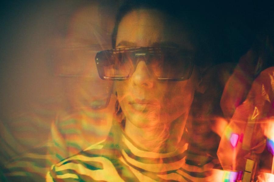 A blurred image of a person's face.