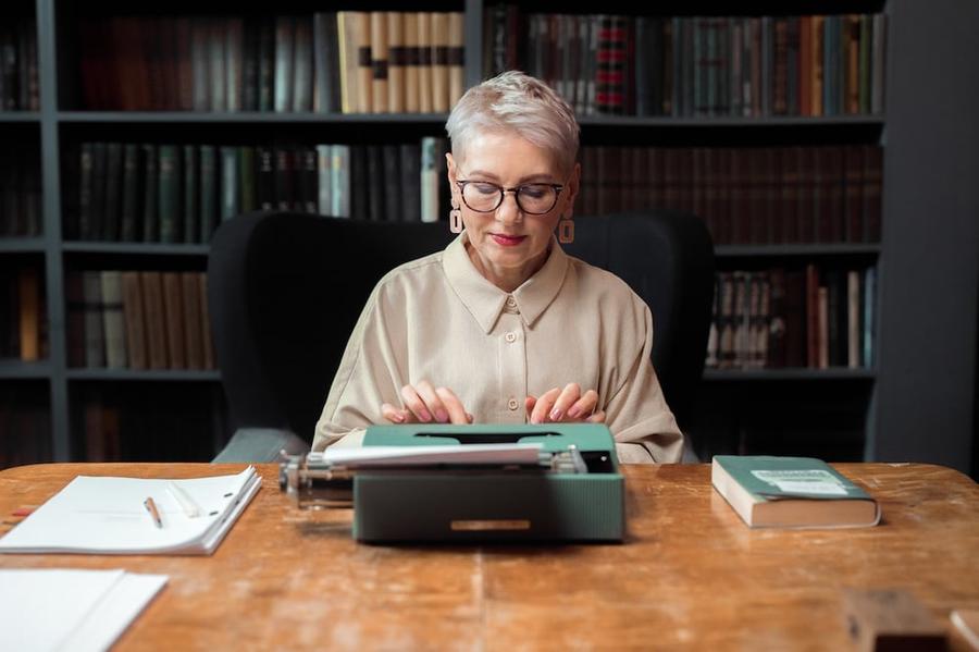 A woman typing on a typewriter.