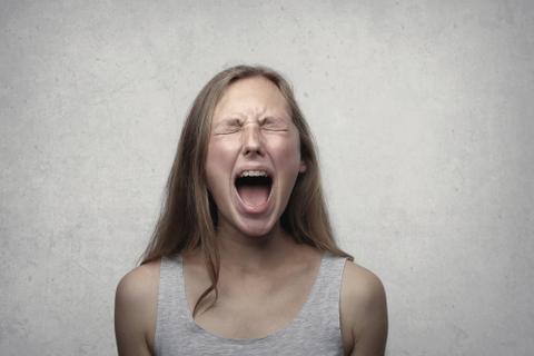A young woman screaming.