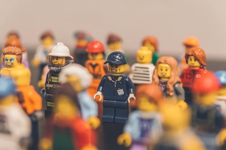 Several different lego characters stand together.