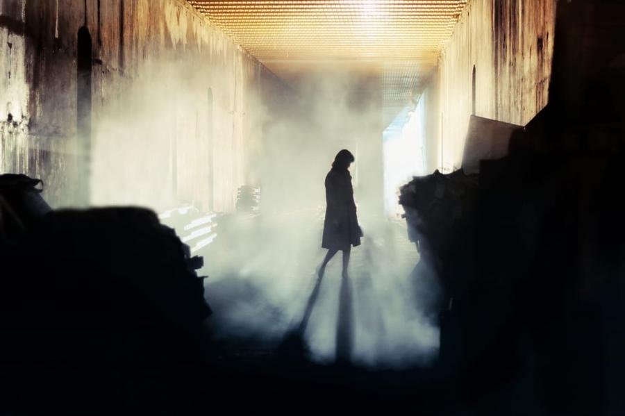 shadowy figure in smoke filled room