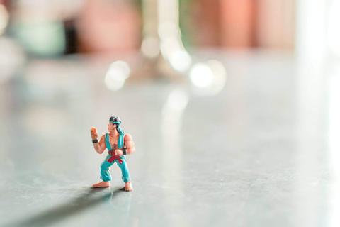 A small action figure on a table.