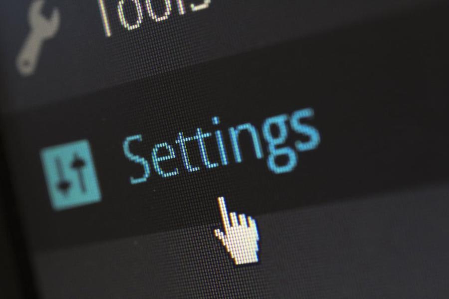 A cursor hovering over the word "settings" on a computer screen.